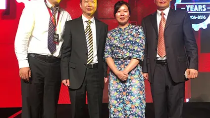 China wins ‘Top Business Partner Award’ from GETRAG. One woman and three men accepting an award