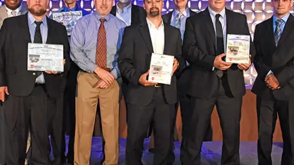 GKN awarded for design excellence by MPIF. Nine men standing on a stage accepting awards