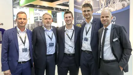 Five men in suits at an event