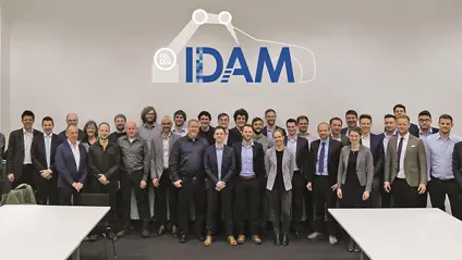 Idam team photo in a meeting room